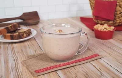 ATOLE de AVELLANA preparado con Alimento en Polvo CARNATION® CLAVEL®